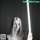 A woman holding a light saber in her hand.