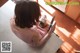 A woman sitting at a table holding a knife.