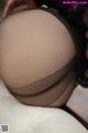 A close up of a woman's butt in black stockings.