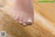 A close up of a person's foot with a pair of white socks.