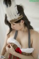 A woman wearing a native american costume with feathers on her head.