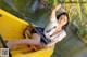 A woman sitting in a yellow boat on a river.