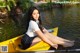 A woman sitting in a yellow kayak on the water.