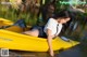 A woman in a yellow kayak on the water.