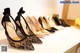 A row of women's shoes lined up on a dresser.