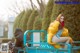 A woman sitting on top of a blue truck.