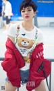 A woman wearing a t-shirt with a teddy bear on it.