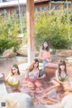 A group of women in bikinis sitting in a hot tub.