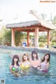 A group of young women in a swimming pool.