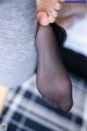 A close up of a woman's feet in black stockings.