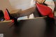 A woman in black stockings and red high heels sitting on a table.