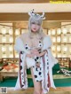 A woman in a cow costume holding a glass of wine.