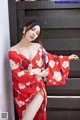 a woman in a red kimono posing for the camera