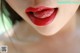 A close up of a woman's lips with red lipstick.